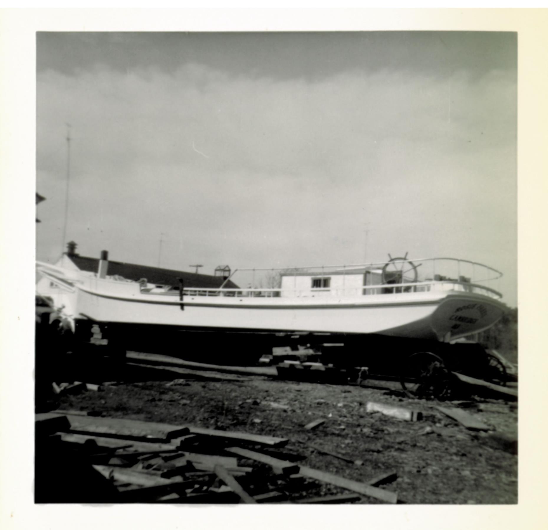 Rosie Parks up on wheeled undercarriage for transport to the water. Steering carriage is visible under the stern. 26 October 1955.