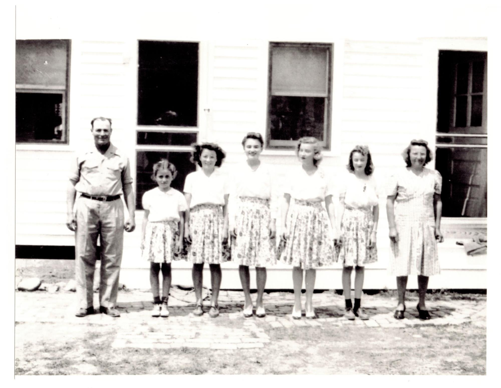 Left to right: Bronza; daughters Joyce, Mary, Lucille, Irene, Martha; wife Katie. No place, no date.
