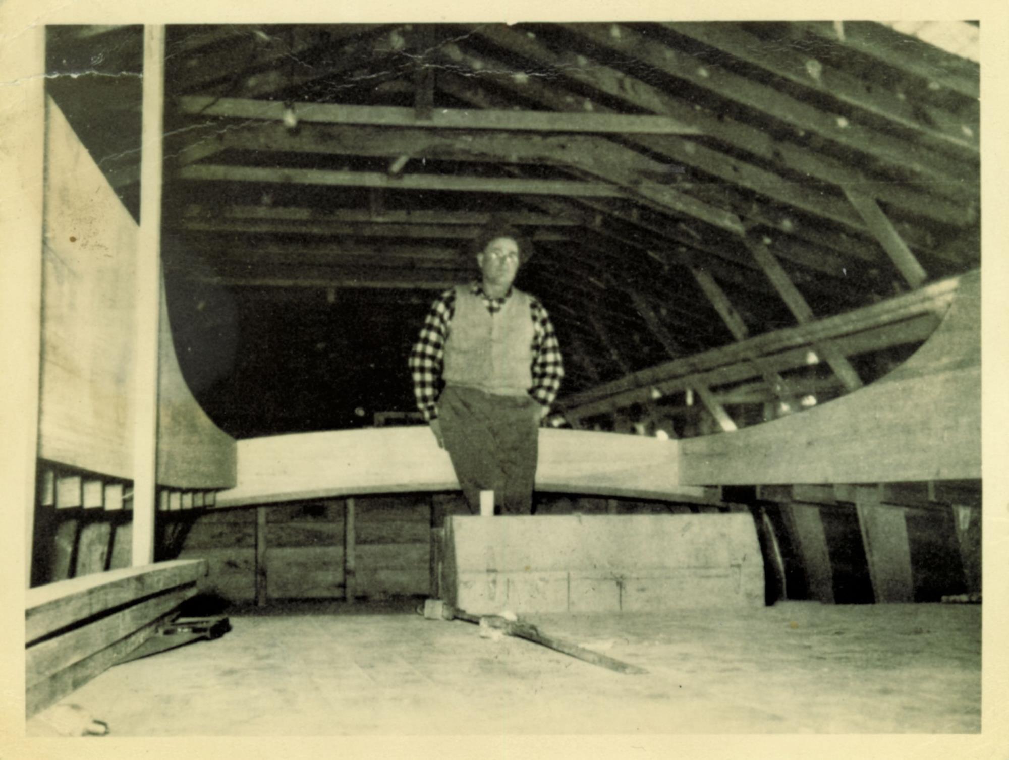 Unidentified worker or client in Bronza's boat shed. Undated.